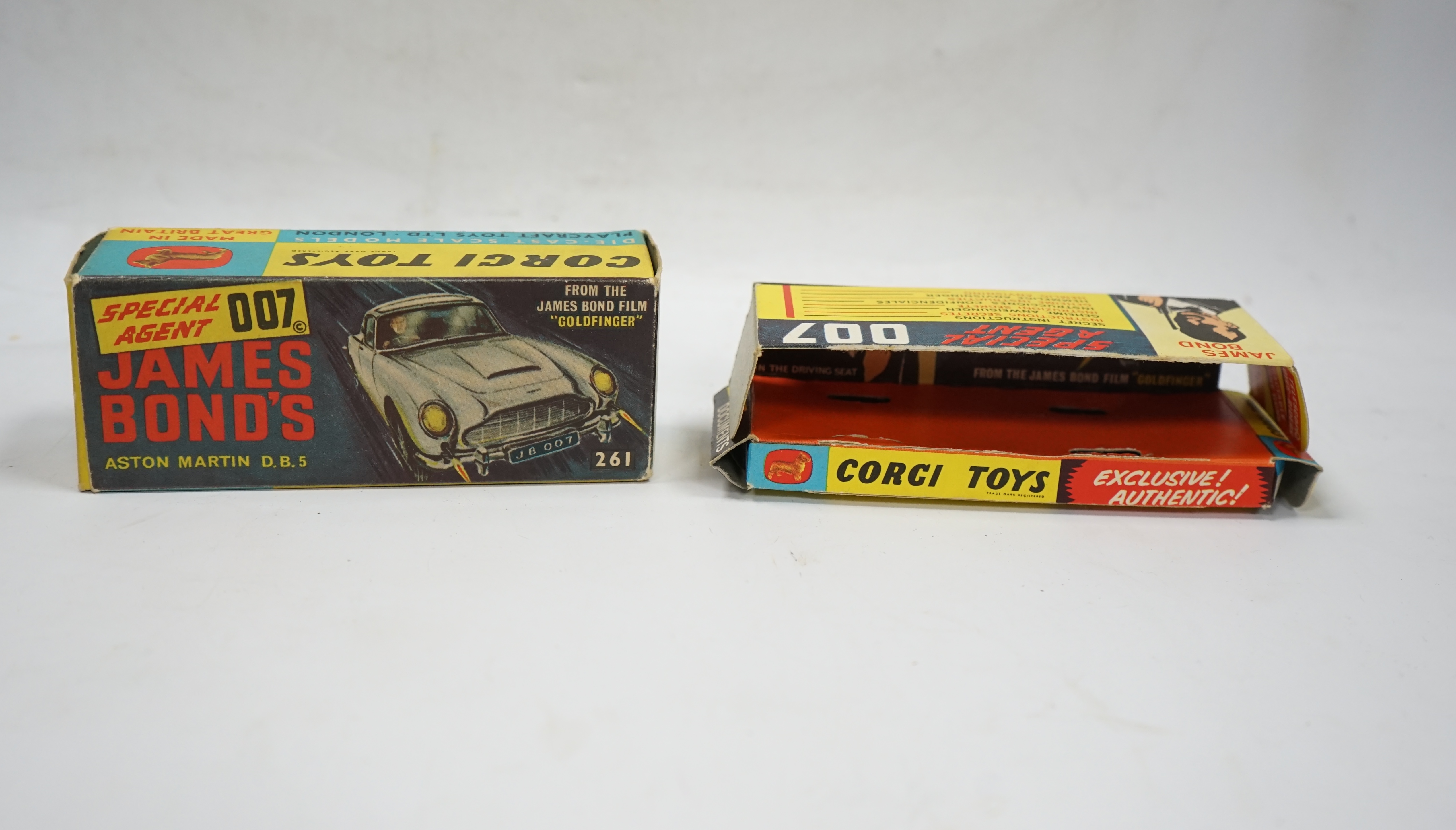 A Corgi Toys (261) James Bond 007 Aston Martin in gold, together with its original box, card display stand, secret instructions and envelope, and an additional spare passenger. Condition fair to good, minor chips to the